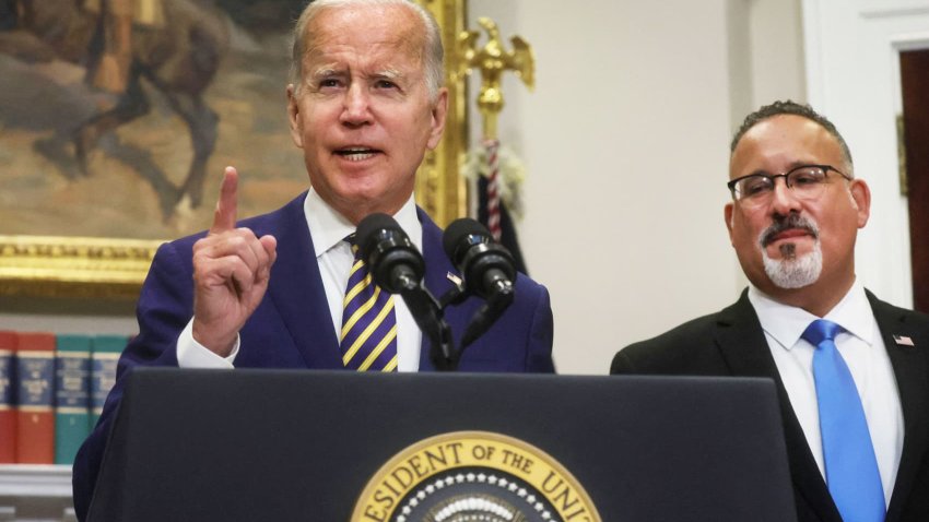 U.S. President Joe Biden is flanked by U.S. Secretary of Education Miguel Cardona as he speaks about administration plans to forgive federal student loan debt during remarks in the Roosevelt Room at the White House in Washington on Aug. 24, 2022.