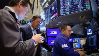 Traders work at the post where GameStop is traded on the floor at the New York Stock Exchange (NYSE) in New York City, U.S., June 12, 2024. 
