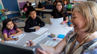 Fifth grade students attend a math lesson with teacher Jana Lamontagne, right, during class at Mount Vernon Community School, in Alexandria, Va., Wednesday, May 1, 2024.