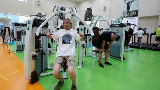 Toshiyuki Honma, 70, uses a chest press machine
