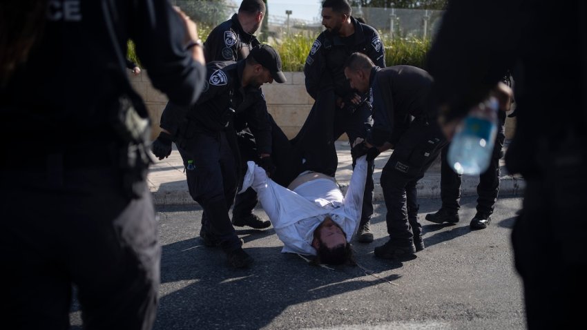 FILE – Israeli police officers remove an ultra-Orthodox Jewish man from the street during a protest against army recruitment in Jerusalem on June 2, 2024. Israel’s Supreme Court on Tuesday, June 25, ruled unanimously that the military must begin drafting ultra-Orthodox men for military service, a decision that could lead to the collapse of Prime Minister Benjamin Netanyahu’s governing coalition as Israel continues to wage war in Gaza.