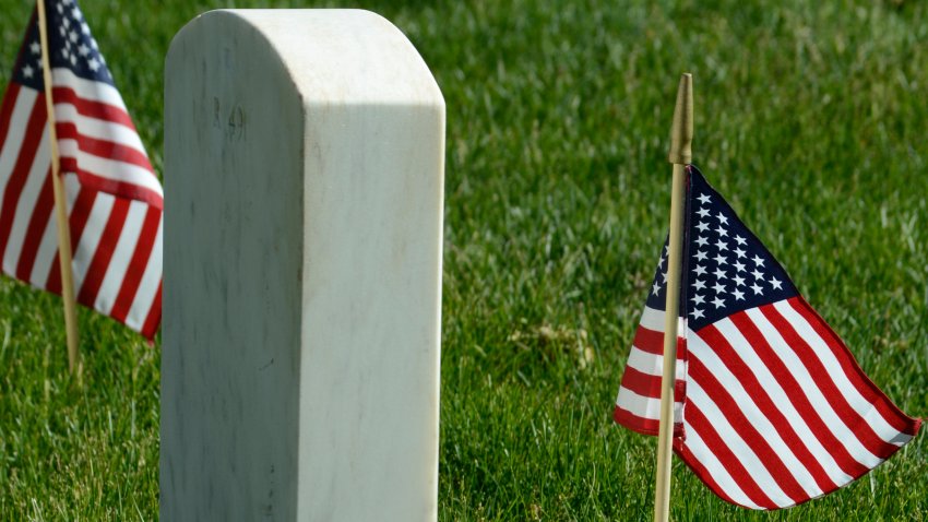 Small American flags decorate the grave of a U.S. veteran.