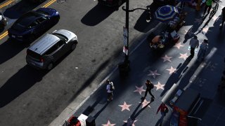 HOLLYWOOD, CALIFORNIA – APRIL 17: People walk along the Hollywood Walk of Fame on Hollywood Boulevard on April 17, 2024 in Hollywood, California.