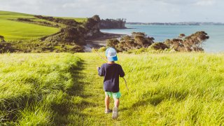 Mixed race kid enjoying outdoors and the authenticity of connecting with nature in Auckland, New Zealand.