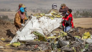 Rescuers work at the scene of an Ethiopian Airlines flight crash near Bishoftu, or Debre Zeit, south of Addis Ababa, Ethiopia, Monday, March 11, 2019.