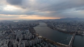 Commercial and residential buildings seen from the rooftop of the Lotte Corp. World Tower at sunset in Seoul, South Korea, on Tuesday, Nov. 28, 2023.