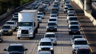 Commuters sit in traffic on southbound Interstate 5 during the afternoon commute heading into downtown San Diego on March 12, 2024 in San Diego, California. 