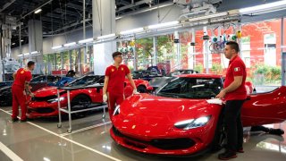 Workers at the new Ferrari NV E-building factory in Maranello, Italy, on Friday, June 21, 2024. The site in Maranello, built over the past couple of years in near-total secrecy, will make Ferrari’s first EV from late 2025 alongside hybrid models and cars powered by combustion engines. Photographer: Francesca Volpi/Bloomberg via Getty Images