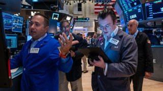 Traders work on the floor of the New York Stock Exchange on July 11, 2024.