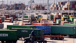 Trucks haul shipping containers at the Port of Los Angeles in San Pedro, California.