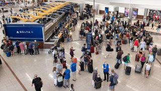 Delta Airlines passengers line up for agent assistance at Hartsfield-Jackson Atlanta International Airport on July 22, 2024 in Atlanta, Georgia. 