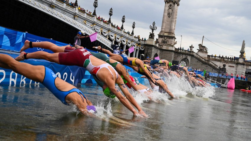 Athletes compete in the swimming race in the Seine