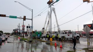 Utility crews work to restore electricity in Houston, Thursday, July 11, 2024.