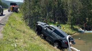 In this photo provided by the National Park Service, a sports utility vehicle is pulled from the inactive Semi-Centennial Geyser in the Wyoming area of Yellowstone National Park on Friday, July 12, 2024.