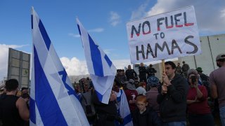 FILE - Israeli police prevent activists from blocking trucks carrying humanitarian aid into the Gaza Strip at the Kerem Shalom border crossing, southern Israel, Monday, Jan. 29, 2024.