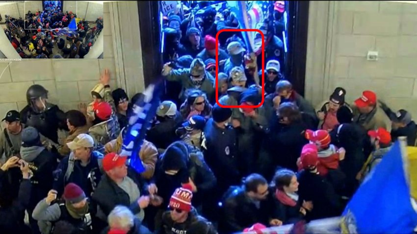 This image from U.S. Capitol Police security video and contained in the government’s sentencing memorandum for Tyler Bradley Dykes, marked in red by source, shows him in the U.S. Capitol on Jan. 6, 2021, in Washington. Dykes, a South Carolina resident and active Marine accused of flashing a Nazi salute during the insurrection, has been sentenced to nearly five years in prison for assaulting police officers who were guarding the building. Dykes grabbed a police riot shield from the hands of two police officers and used it to push his way through police lines at the Capitol.