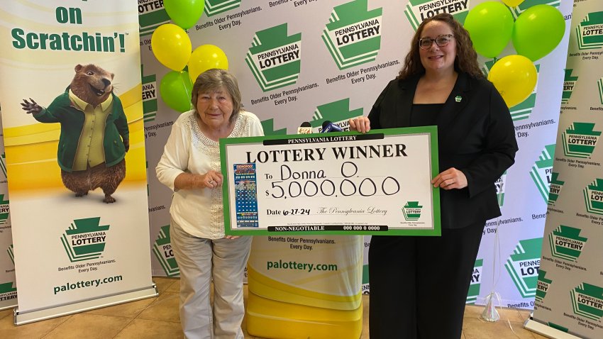 Donna Osborne, 75, left, posing for a photo with PA Lottery Deputy Director of Corporate Sales Staci Coombs at Lottery Headquarters in Middletown, Pa.