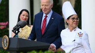 File. President Joe Biden brings to the podium White House US-Filipino chef Cristeta Comerford.