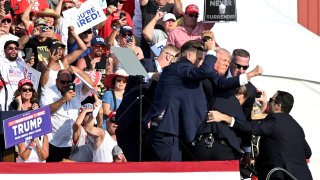 President Donald Trump flanked by Secret Service