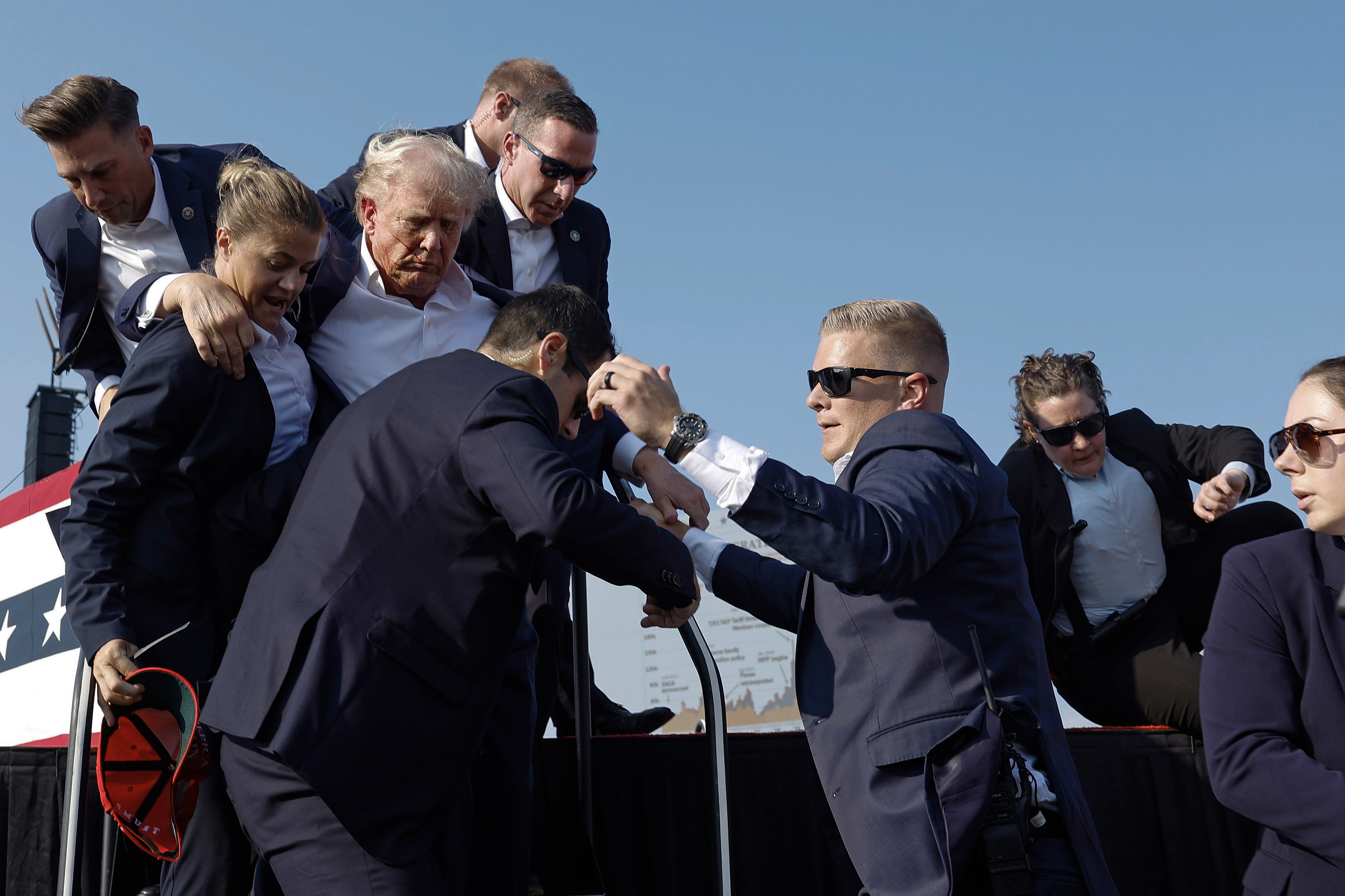 Republican presidential candidate former President Donald Trump is rushed offstage by U.S. Secret Service agents on July 13, 2024 in Butler, Pennsylvania.