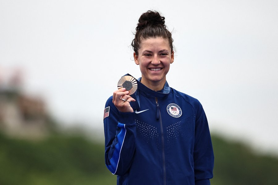 Chloe Dygert celebrates with her bronze medal