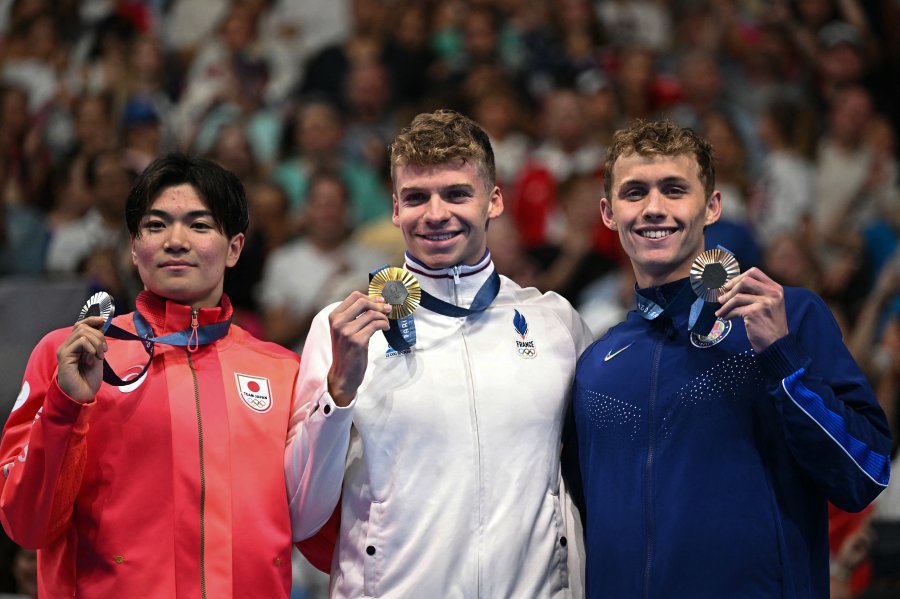 Silver medallist Japan's Tomoyuki Matsushita, gold medallist France's Leon Marchand and bronze medallist US' Carson Foster