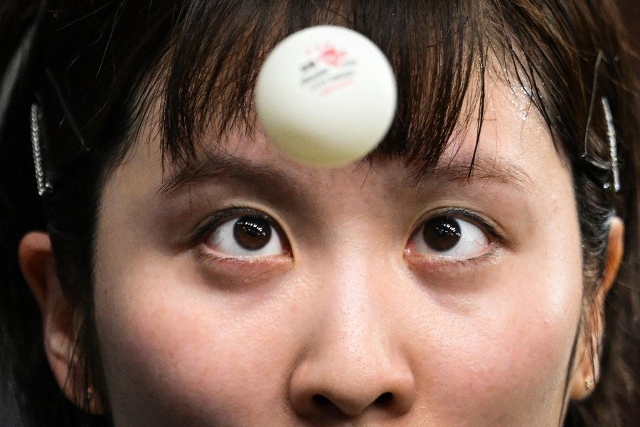 Japan's Miu Hirano eyes the ball as she prepares to serve to Italy's Giorgia Piccolin during their women's table tennis singles round of 64 at the Paris 2024 Olympic Games.