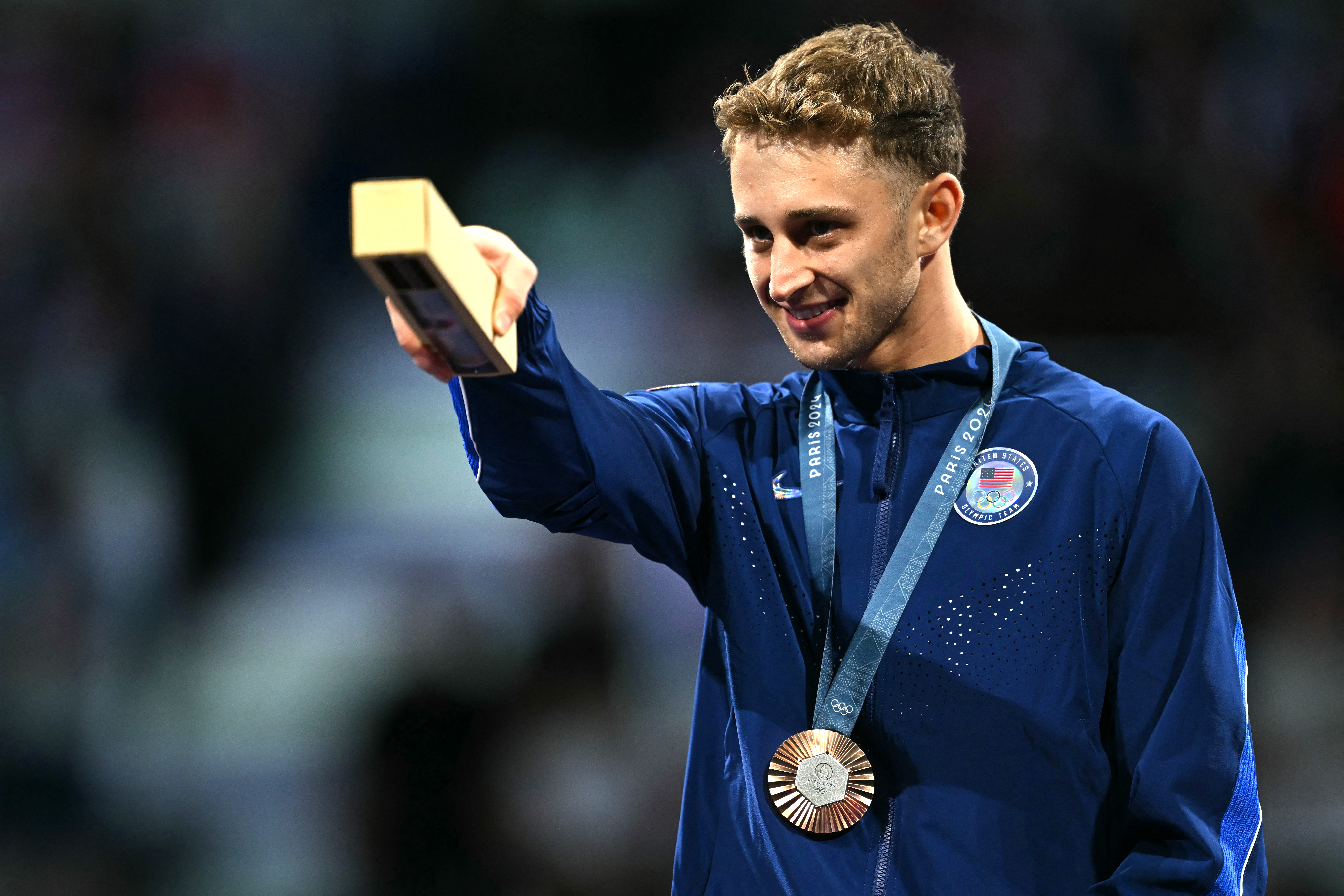 Bronze medallist US’ Nick Itkin, of Palisades High School, celebrates on the podium during the medal ceremony for the men’s foil individual competition during the Paris 2024 Olympic Games on July 29, 2024.