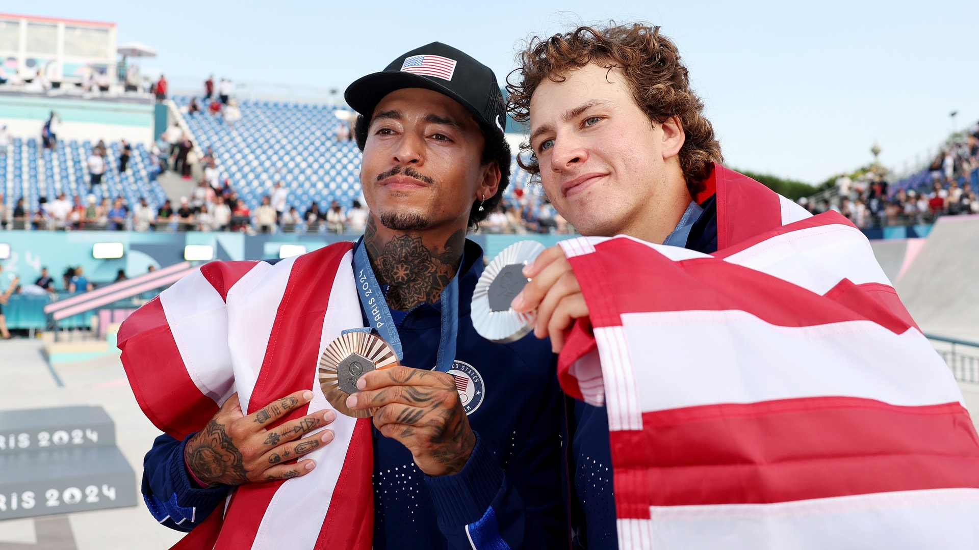 Americans Nyjah Huston (L), of Laguna Beach, and Jagger Eaton, of Cardiff, pose with their bronze and silver medals following the men’s skateboard street final at Place de la Concorde in Paris, France.