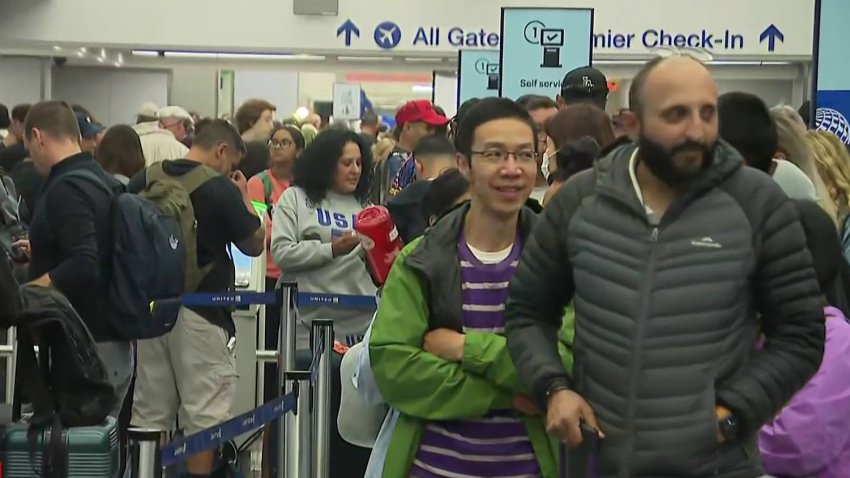 Travelers wait at LAX Friday July 19, 2024.