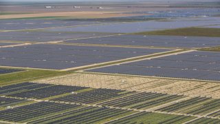 A large array of solar panels along Highway 41 are located in close proximity to the growing Tulare Lake, a once great body of water in the southern Central Valley, now beginning to fill again due to the recent series of major rain and snow storms in the Sierra Nevada, is viewed on April 13, 2023, near Stratford, California. 