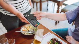 Paying for food and drinks at a cafe is made easy with credit cards.