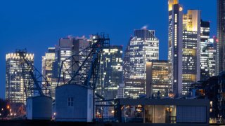 The lights of Frankfurt am Main’s banking skyline glow in the last light of day.