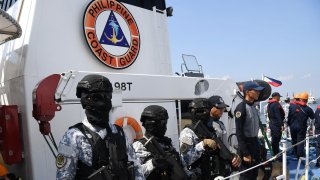 Philippine Coast Guard law enforcement command personnel stand aboard the BRP Bagacay during a send-off ceremony in Manila on May 20, 2024.