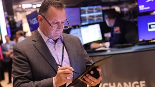 Traders work on the floor of the New York Stock Exchange during morning trading on Aug. 20, 2024.