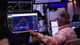 Traders work on the floor of the New York Stock Exchange during morning trading on August 20, 2024 in New York City.