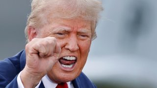 Republican presidential nominee and former U.S. President Donald Trump speaks from behind bulletproof glass during a campaign rally, at the North Carolina Aviation Museum & Hall of Fame in Asheboro, North Carolina, U.S. August 21, 2024.