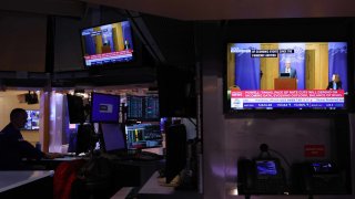 Financial news is displayed on a television on the floor of the New York Stock Exchange during morning trading on Aug. 23, 2024.