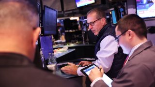 Traders work on the floor of the New York Stock Exchange during morning trading on August 23, 2024 in New York City. 