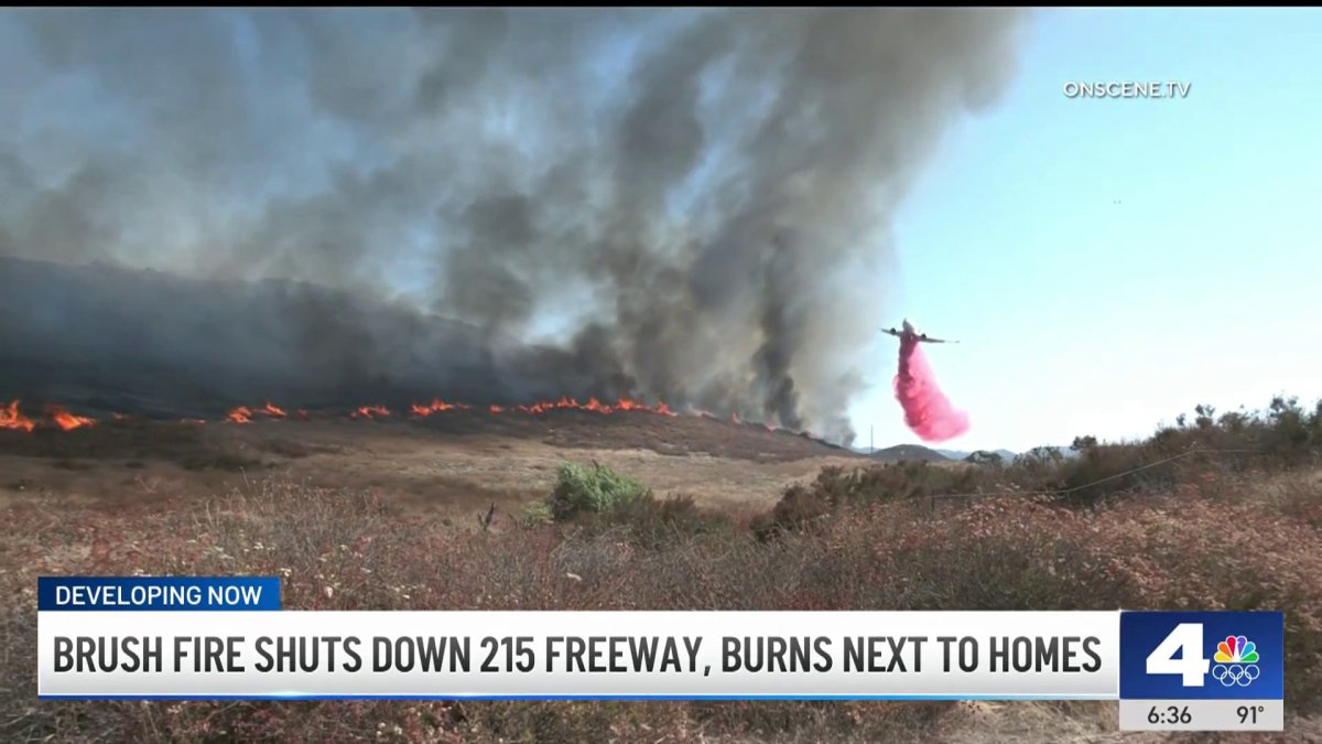 Brush fire shuts down 215 freeway, burns next to homes – NBC Los Angeles