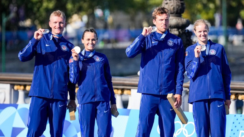 US triathletes pose with medals after race.