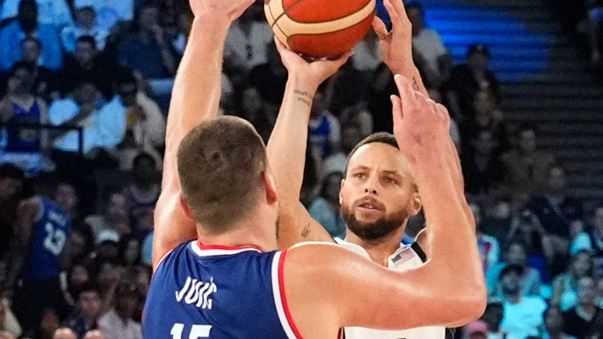 Steph Curry shoots over Jokic