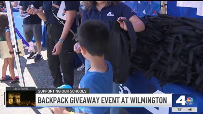 Families line up for Telemundo 52 and NBC4 backpack giveaway event at Wilmington