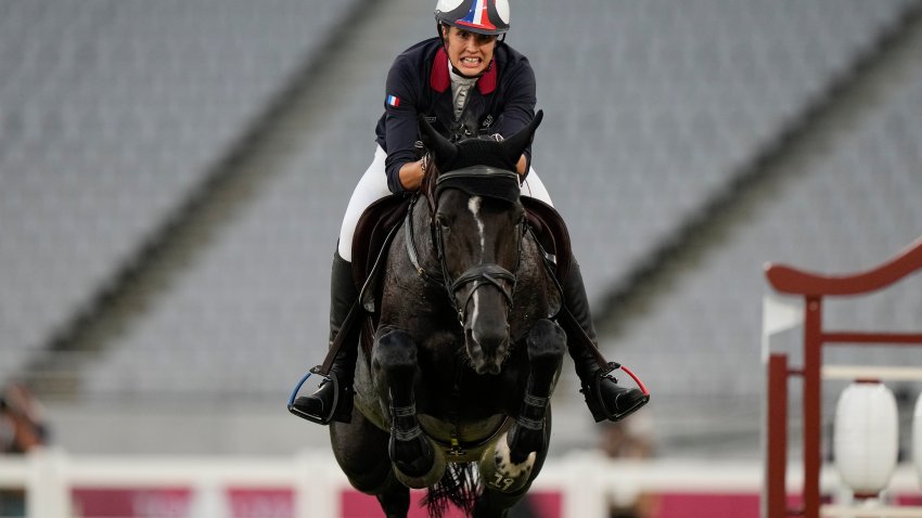 FILE – Elodie Clouvel of France competes in the horse jumping portion of the women’s modern pentathlon at the 2020 Summer Olympics, Friday, Aug. 6, 2021, in Tokyo, Japan.