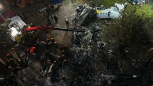 Firefighters and rescue workers work in the debris at the site where an airplane with 61 people on board crashed in Vinhedo, Sao Paulo state, Brazil, Saturday Aug. 10, 2024. (AP Photo/Andre Penner)