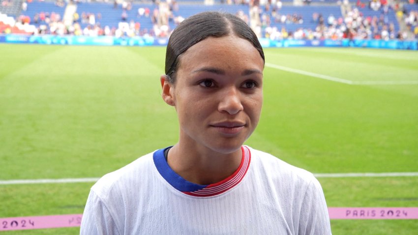 Sophia Smith speaks to a reporter on the field after a game