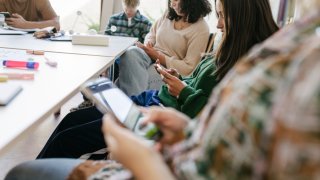 Students Looking At Their Smartphones During Class