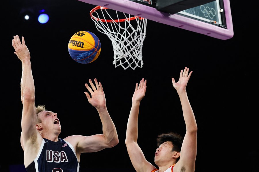 US' Canyon Barry (left) fights for the ball China's Zhao Jiaren (right