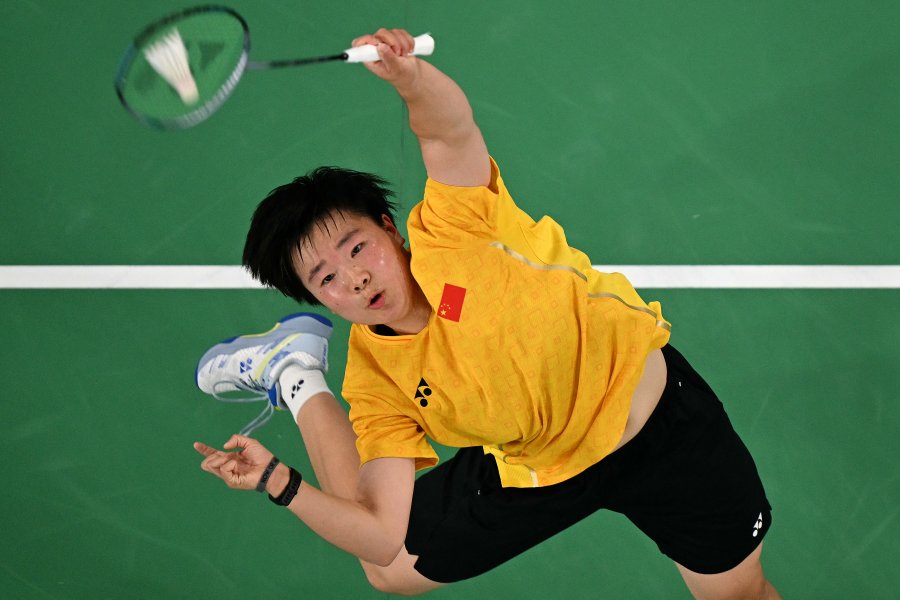 China's He Bing Jiao plays a shot against Spain's Carolina Marin in their women's singles badminton semi-final match during the Paris 2024 Olympic Games at Porte de la Chapelle Arena in Paris on August 4, 2024