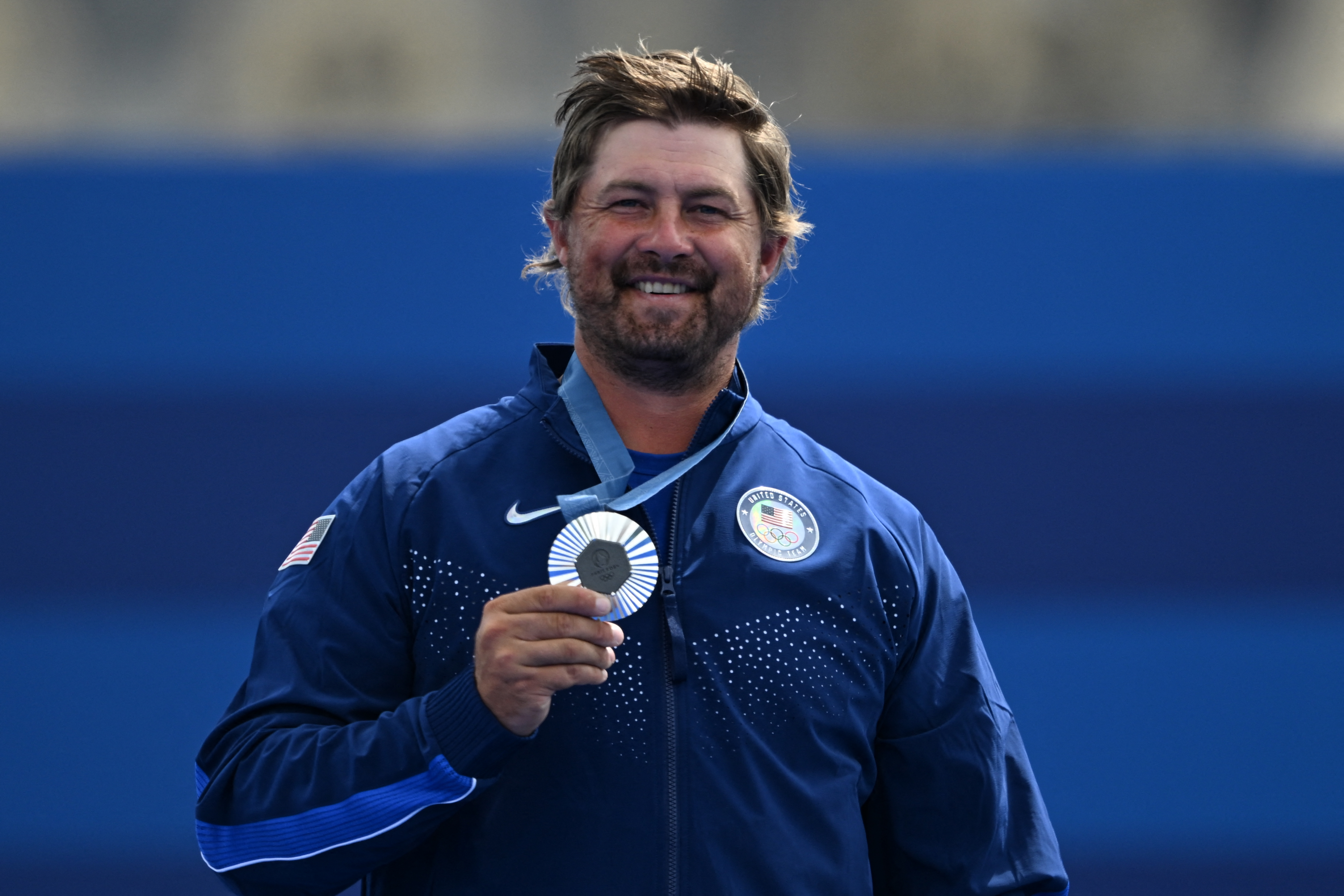 Brady Ellison, of Chula Vista, is seen with his silver medal in men's archery. The final came down to final arrows that were just millimeters apart.